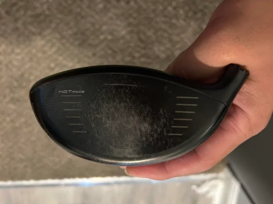 Golf driver without protective headcover showing risk of scratches and damage